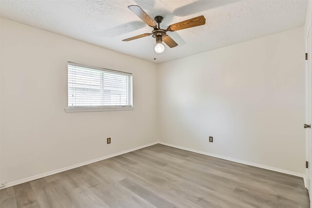 3915 Rosemont Dr, La Porte, TX 77571 - spare room featuring wood finished floors, baseboards, and a textured ceiling