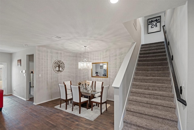 21512 Rustic Elm Dr, New Caney, TX 77357 - dining space with stairs, wood finished floors, baseboards, and a chandelier