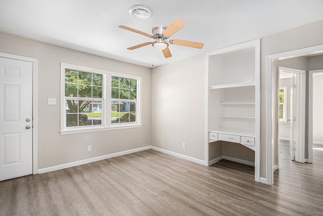 7306 Lakewood Dr, Houston, TX 77016 - unfurnished living room featuring wood finished floors, baseboards, ceiling fan, and an office area