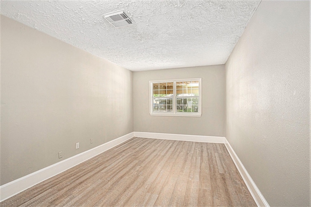 7306 Lakewood Dr, Houston, TX 77016 - unfurnished room featuring wood finished floors, baseboards, and a textured ceiling