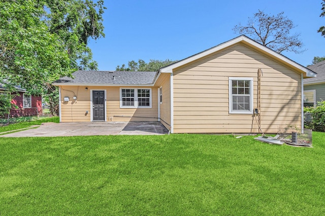 7306 Lakewood Dr, Houston, TX 77016 - back of property featuring a patio area, a yard, and a shingled roof
