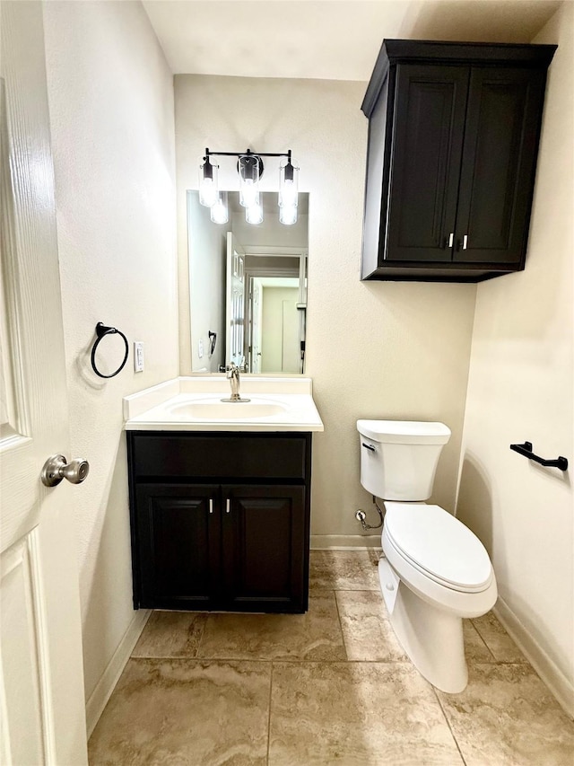 7600 Emmett F Lowry Expy Unit 409, Texas City, TX 77591 - half bathroom featuring toilet, vanity, and baseboards