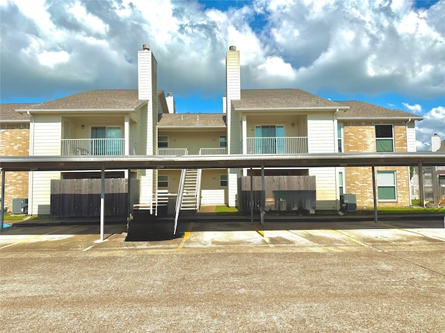 7600 Emmett F Lowry Expy Unit 409, Texas City, TX 77591 - rear view of property with central AC unit and covered parking