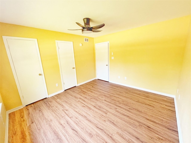 803 Wolley Cir, Crockett, TX 75835 - unfurnished bedroom featuring wood finished floors, baseboards, and ceiling fan