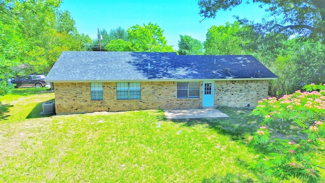 803 Wolley Cir, Crockett, TX 75835 - rear view of property with a patio, brick siding, and a lawn