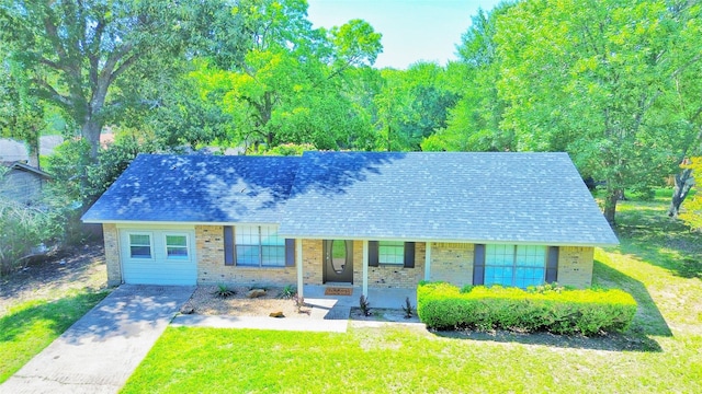 803 Wolley Cir, Crockett, TX 75835 - view of front of home featuring a porch, a front lawn, brick siding, and roof with shingles