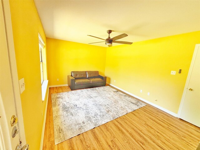 803 Wolley Cir, Crockett, TX 75835 - unfurnished living room featuring wood finished floors, a ceiling fan, and baseboards