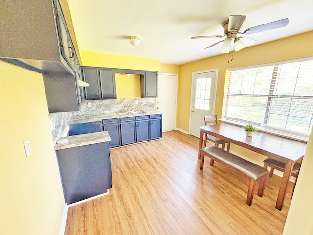 803 Wolley Cir, Crockett, TX 75835 - kitchen featuring light wood finished floors, backsplash, light countertops, a ceiling fan, and baseboards