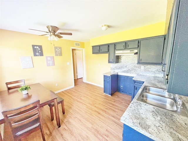 803 Wolley Cir, Crockett, TX 75835 - kitchen featuring under cabinet range hood, a ceiling fan, light wood-style flooring, a sink, and light countertops