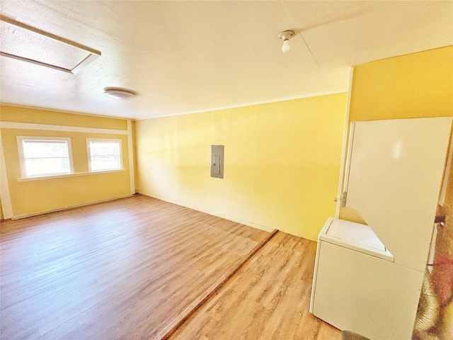803 Wolley Cir, Crockett, TX 75835 - spare room featuring light wood finished floors, electric panel, and attic access