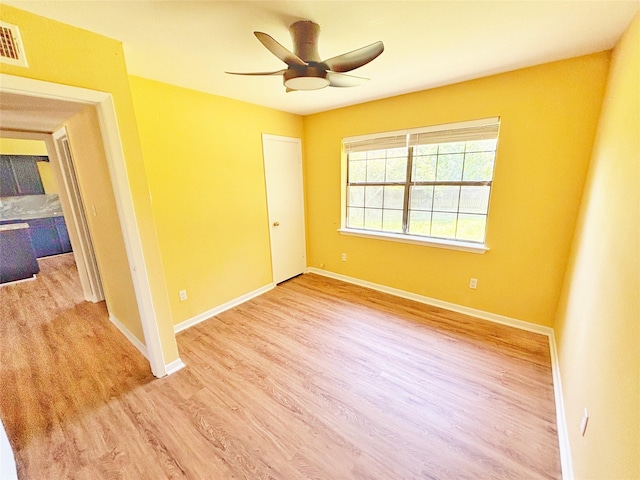 803 Wolley Cir, Crockett, TX 75835 - unfurnished room featuring wood finished floors, a ceiling fan, and baseboards