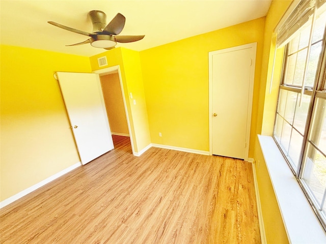 803 Wolley Cir, Crockett, TX 75835 - empty room featuring light wood-style flooring, ceiling fan, and baseboards