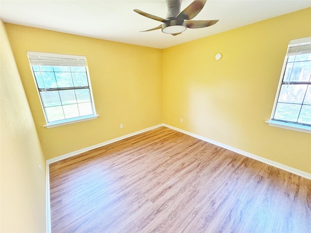 803 Wolley Cir, Crockett, TX 75835 - empty room with wood finished floors, a ceiling fan, and baseboards