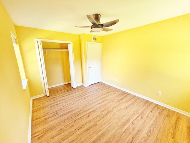 803 Wolley Cir, Crockett, TX 75835 - unfurnished bedroom with wood finished floors, a closet, baseboards, and a ceiling fan