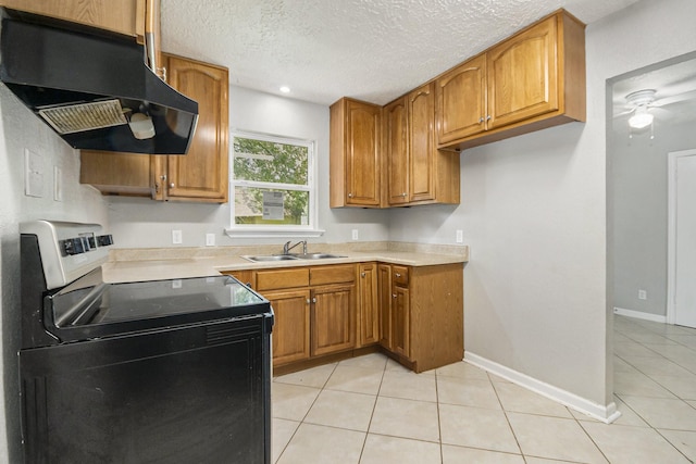 2705 Camille St, Pasadena, TX 77506 - kitchen featuring under cabinet range hood, stainless steel range with electric stovetop, a sink, brown cabinets, and light tile patterned floors