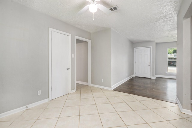 2705 Camille St, Pasadena, TX 77506 - spare room featuring a textured ceiling, a ceiling fan, baseboards, and light tile patterned floors
