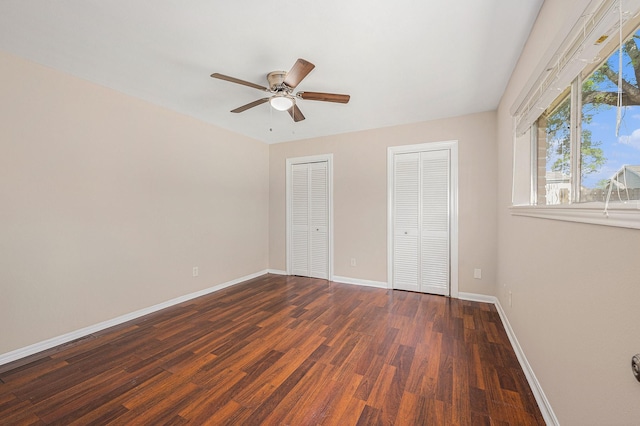 6046 W Airport Blvd, Houston, TX 77035 - unfurnished bedroom featuring two closets, wood finished floors, baseboards, and a ceiling fan