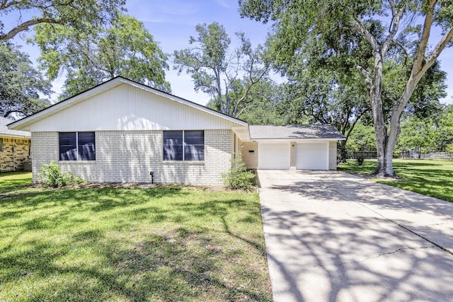 3010 Lamar Cir, El Campo, TX 77437 - view of front of home featuring brick siding, a garage, and concrete driveway