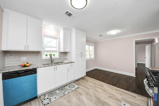 129 E 6th St, Deer Park, TX 77536 - kitchen featuring dishwashing machine, a sink, stainless steel gas stove, baseboards, and ornamental molding