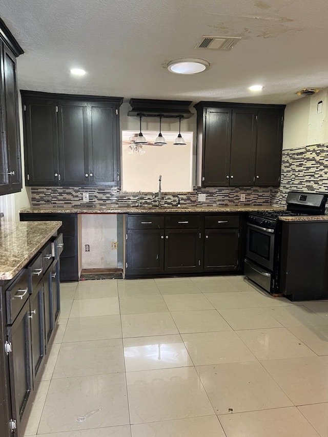 1506 Grand Valley Dr, Houston, TX 77090 - kitchen featuring stainless steel range with gas cooktop, a sink, tasteful backsplash, stone counters, and recessed lighting