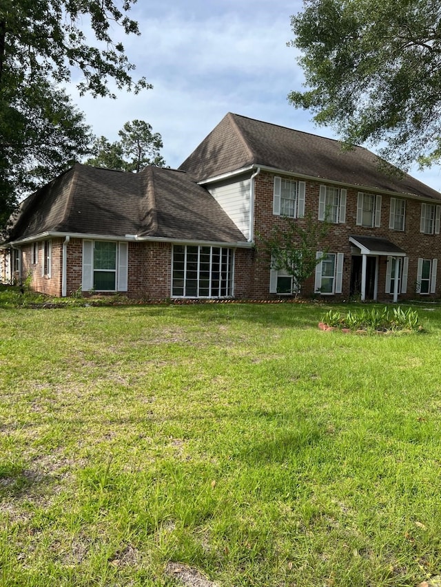 1506 Grand Valley Dr, Houston, TX 77090 - rear view of house with brick siding and a lawn