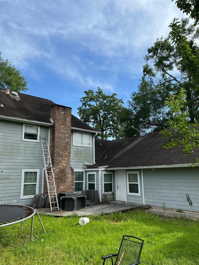 1506 Grand Valley Dr, Houston, TX 77090 - rear view of house with a patio area, a chimney, a lawn, and central air condition unit