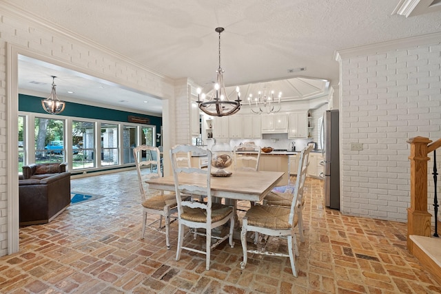 23025 Jane Rd, Tomball, TX 77377 - dining space featuring a chandelier, brick floors, ornamental molding, and a textured ceiling