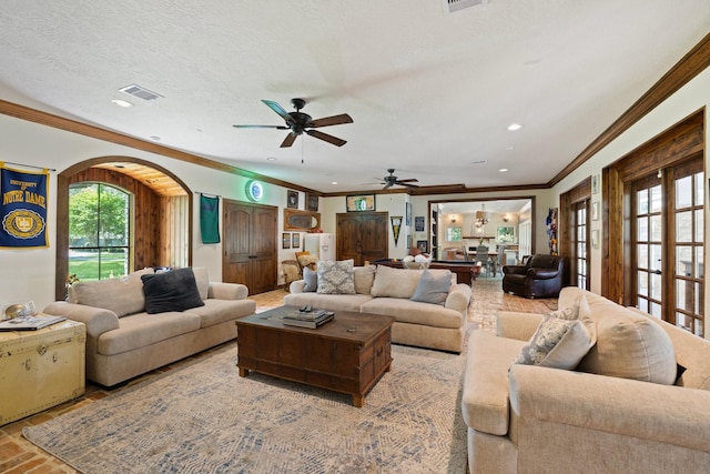 23025 Jane Rd, Tomball, TX 77377 - living room with ornamental molding, ceiling fan, recessed lighting, arched walkways, and a textured ceiling