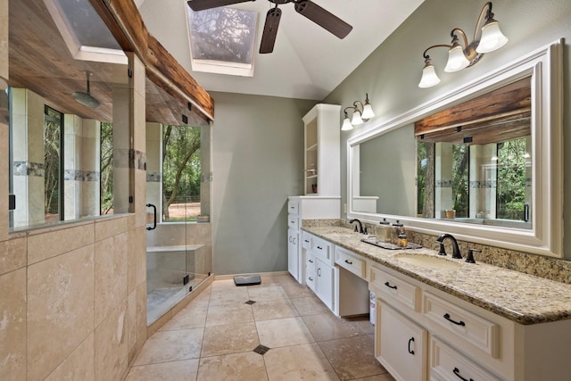 23025 Jane Rd, Tomball, TX 77377 - bathroom featuring ceiling fan, double vanity, a stall shower, a skylight, and vaulted ceiling