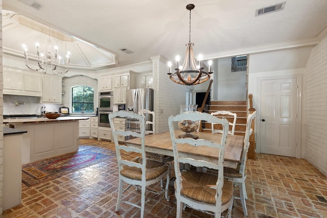 23025 Jane Rd, Tomball, TX 77377 - dining room with a chandelier, brick flooring, ornamental molding, and brick wall