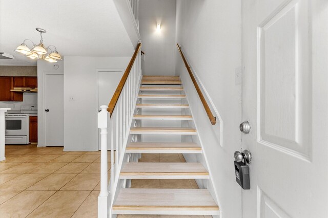 3100 Jeanetta St Unit 606, Houston, TX 77063 - stairway featuring a chandelier and tile patterned floors