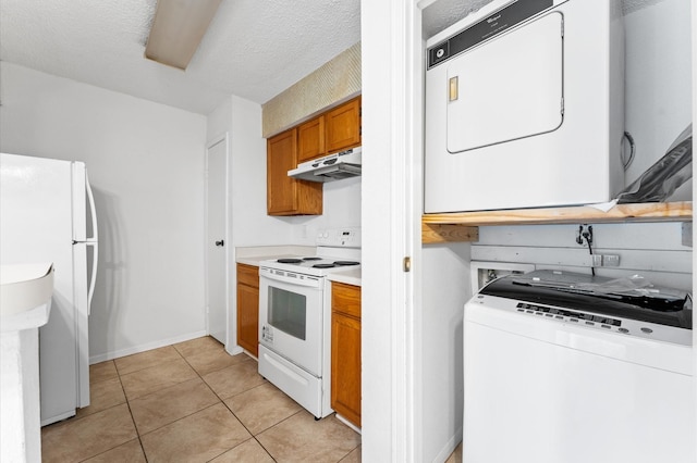 3100 Jeanetta St Unit 606, Houston, TX 77063 - kitchen featuring white appliances, under cabinet range hood, stacked washer / dryer, brown cabinetry, and light countertops