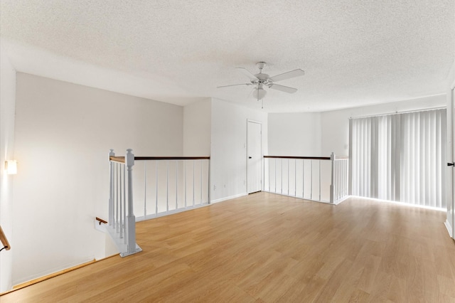 3100 Jeanetta St Unit 606, Houston, TX 77063 - empty room with light wood-type flooring, ceiling fan, and a textured ceiling