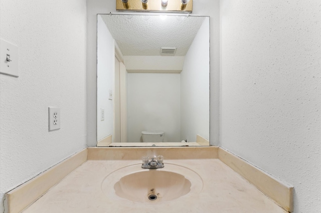 3100 Jeanetta St Unit 606, Houston, TX 77063 - bathroom featuring toilet, vanity, and a textured wall