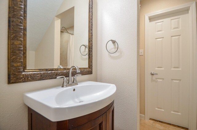 13523 Spring Ct, Tomball, TX 77375 - bathroom featuring a textured wall and vanity