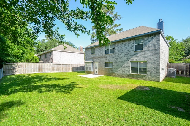 13523 Spring Ct, Tomball, TX 77375 - back of property with a chimney, brick siding, cooling unit, and a patio