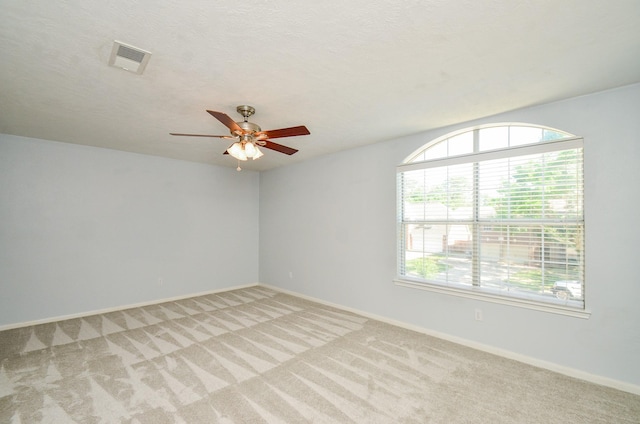 13523 Spring Ct, Tomball, TX 77375 - empty room featuring light colored carpet, a ceiling fan, and baseboards
