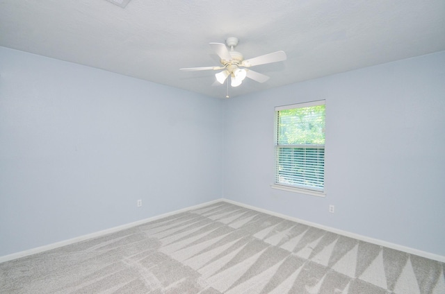 13523 Spring Ct, Tomball, TX 77375 - empty room with light colored carpet, baseboards, and ceiling fan