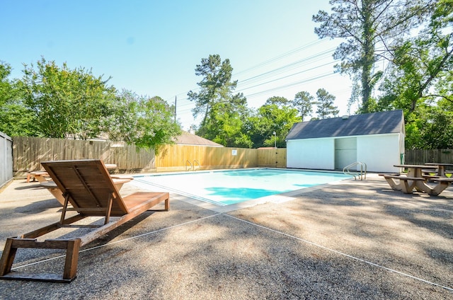 13523 Spring Ct, Tomball, TX 77375 - view of swimming pool with a patio area, a fenced backyard, and an outdoor structure