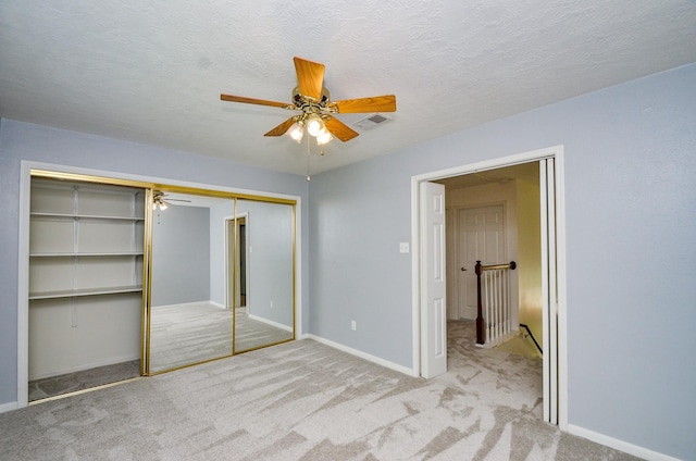 13523 Spring Ct, Tomball, TX 77375 - unfurnished bedroom with carpet, a closet, ceiling fan, baseboards, and a textured ceiling