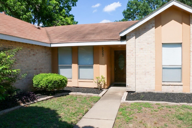 9922 Hibernia Dr, Houston, TX 77088 - property entrance featuring brick siding and roof with shingles