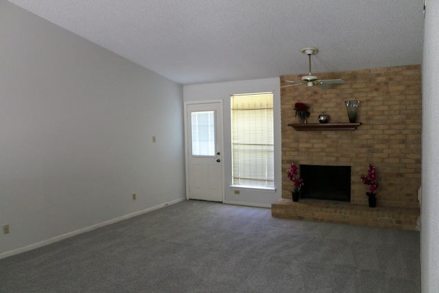 9922 Hibernia Dr, Houston, TX 77088 - unfurnished living room featuring a ceiling fan, carpet, baseboards, a brick fireplace, and a textured ceiling