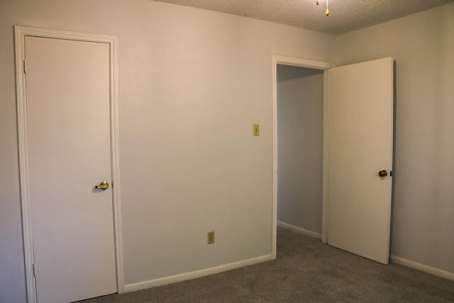 9922 Hibernia Dr, Houston, TX 77088 - unfurnished bedroom featuring carpet flooring, a textured ceiling, and baseboards