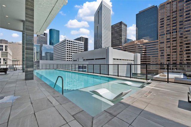 1211 Caroline St Unit 908, Houston, TX 77002 - community pool featuring a view of skyline and a patio area