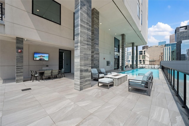 1211 Caroline St Unit 908, Houston, TX 77002 - view of patio featuring outdoor dining area, a community pool, and outdoor lounge area
