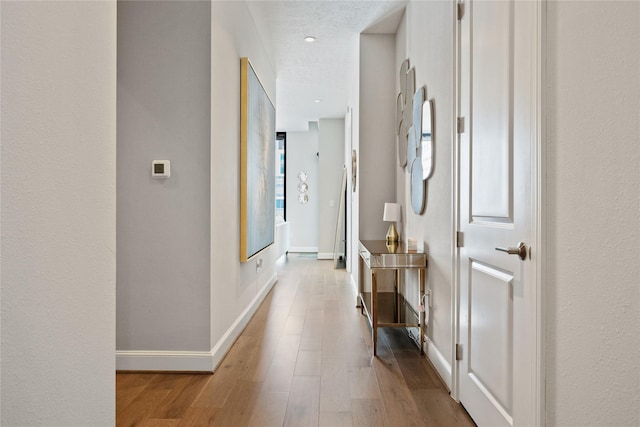 1211 Caroline St Unit 908, Houston, TX 77002 - hall featuring wood finished floors and baseboards