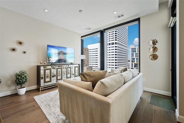 1211 Caroline St Unit 908, Houston, TX 77002 - living area featuring baseboards, dark wood-type flooring, and recessed lighting