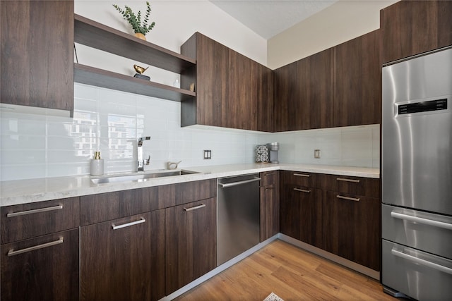 1211 Caroline St Unit 908, Houston, TX 77002 - kitchen featuring stainless steel appliances, open shelves, modern cabinets, and dark brown cabinetry