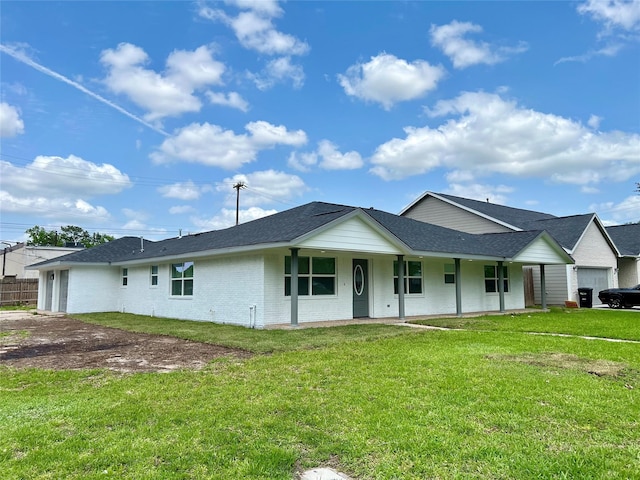 803 Hackberry St, Stafford, TX 77477 - view of front facade featuring a front yard, roof with shingles, brick siding, and covered porch