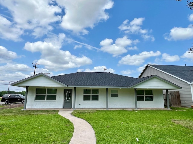 803 Hackberry St, Stafford, TX 77477 - view of front of house featuring roof with shingles, a front yard, and brick siding